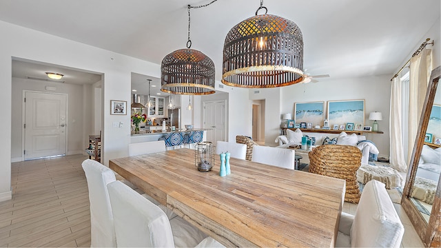 dining area with baseboards and ceiling fan