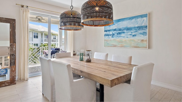 dining space featuring wood finished floors and baseboards