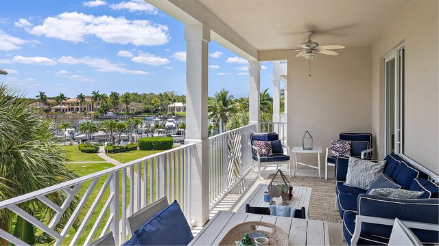 balcony with an outdoor living space and ceiling fan