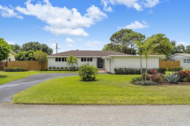 single story home with fence, a front lawn, and aphalt driveway