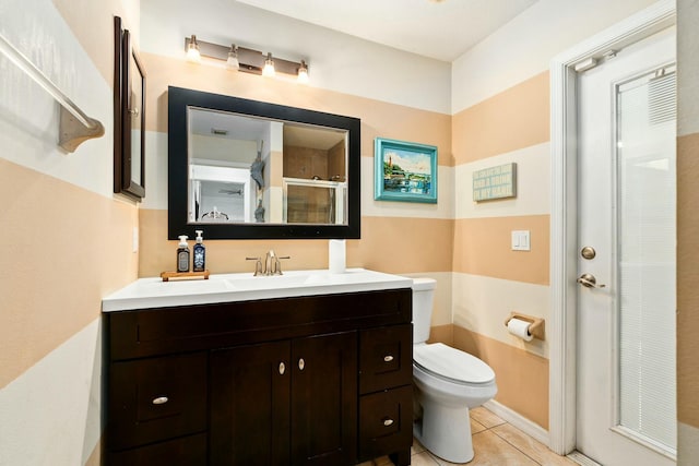 bathroom featuring a shower stall, tile patterned flooring, vanity, and toilet