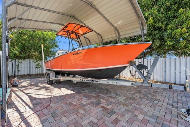 view of vehicle parking with a carport and fence