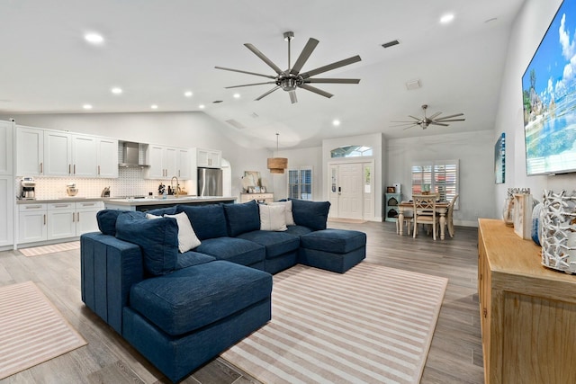 living area with visible vents, ceiling fan, recessed lighting, and high vaulted ceiling