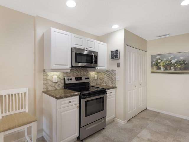 14586 Lucy Dr, Delray Beach, FL 33484 - kitchen with white cabinets, visible vents, baseboards, decorative backsplash, and appliances with stainless steel finishes