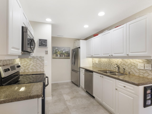 14586 Lucy Dr, Delray Beach, FL 33484 - kitchen featuring a sink, decorative backsplash, stainless steel appliances, baseboards, and white cabinetry
