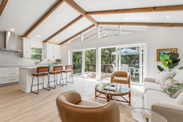 living area with vaulted ceiling with beams, recessed lighting, and light wood-style floors