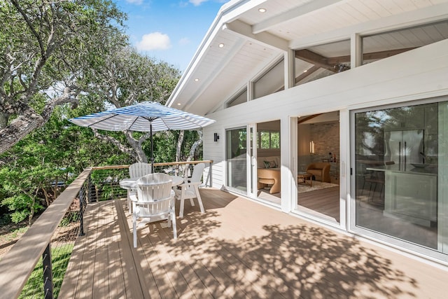 wooden deck featuring outdoor dining area