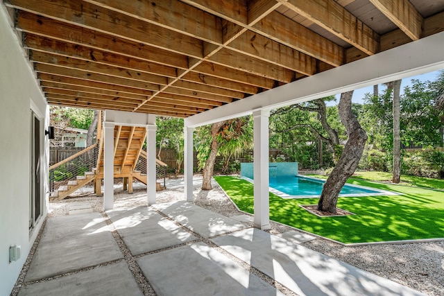 view of patio / terrace with stairway, an outdoor pool, and a fenced backyard