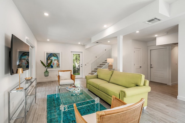living area featuring recessed lighting, stairway, visible vents, baseboards, and light wood-style flooring