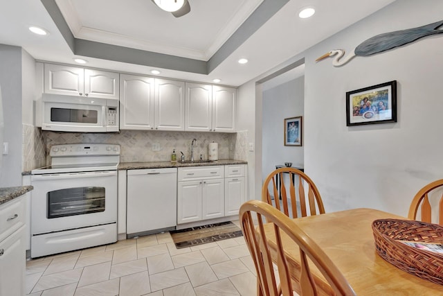 kitchen with recessed lighting, white appliances, white cabinetry, crown molding, and a sink