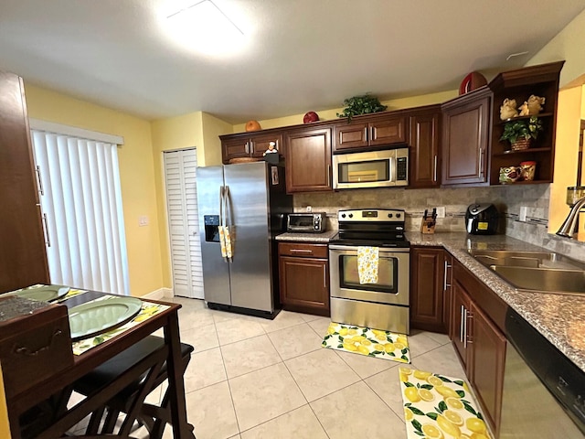 4330 Lucerne Villas Ln, Lake Worth, FL 33467 - kitchen featuring tasteful backsplash, open shelves, dark brown cabinets, a sink, and stainless steel appliances