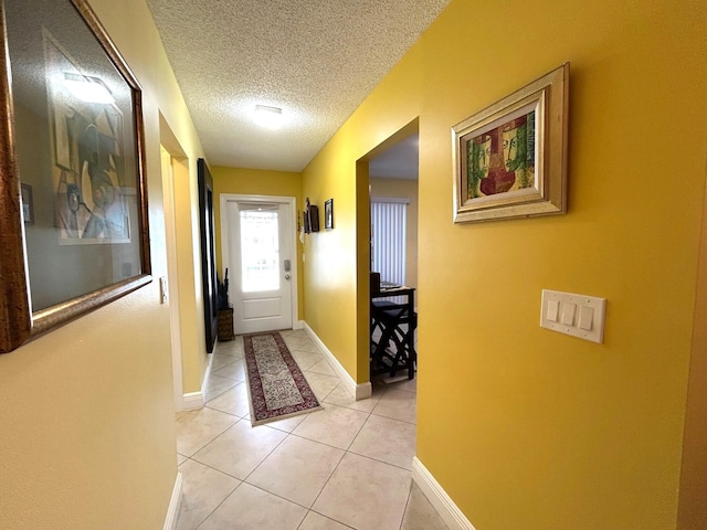 4330 Lucerne Villas Ln, Lake Worth, FL 33467 - hall with baseboards, a textured ceiling, and light tile patterned floors
