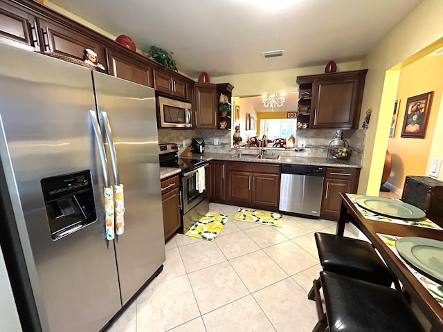 4330 Lucerne Villas Ln, Lake Worth, FL 33467 - kitchen with decorative backsplash, open shelves, stainless steel appliances, and visible vents