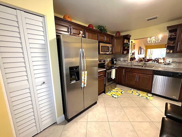 4330 Lucerne Villas Ln, Lake Worth, FL 33467 - kitchen with visible vents, tasteful backsplash, open shelves, a sink, and stainless steel appliances