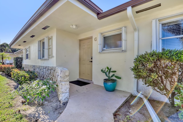2894 Crosley Dr E Unit G, West Palm Beach, FL 33415 - view of exterior entry with stucco siding