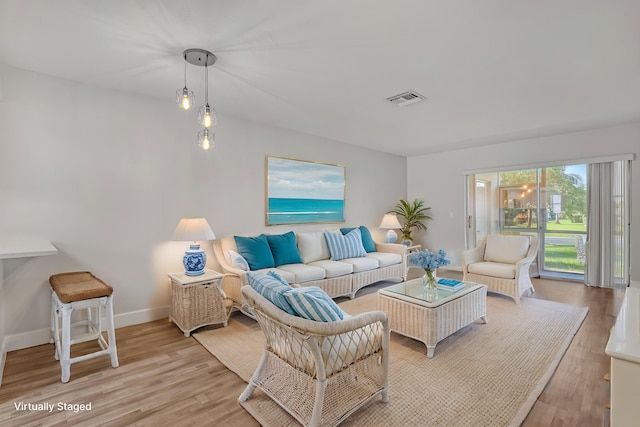 2894 Crosley Dr E Unit G, West Palm Beach, FL 33415 - living room featuring baseboards, visible vents, and light wood-type flooring