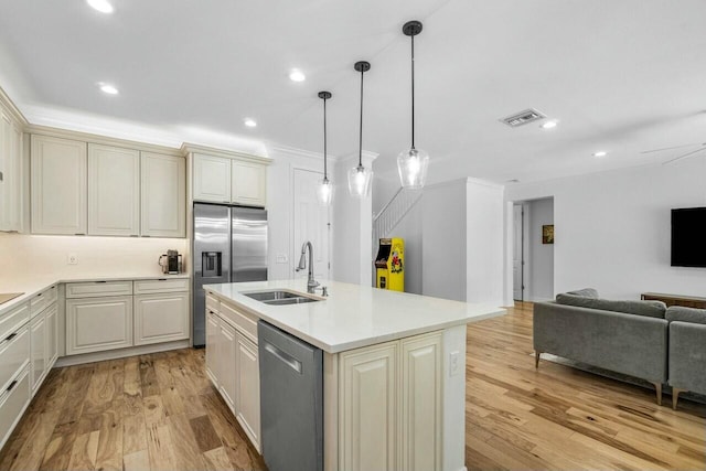 kitchen featuring a sink, stainless steel appliances, visible vents, light countertops, and open floor plan