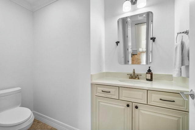 half bathroom featuring baseboards, ornamental molding, toilet, and vanity