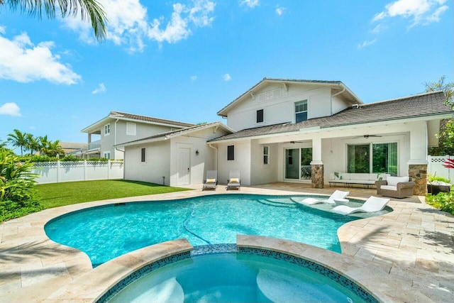 rear view of house with fence, a ceiling fan, an outdoor hangout area, and stucco siding