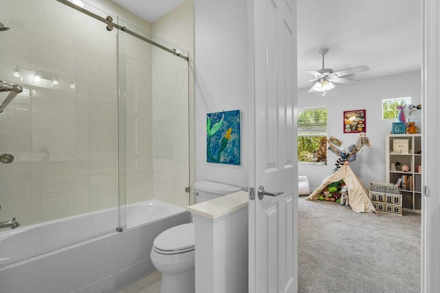 bathroom with shower / bath combination with glass door, a ceiling fan, and toilet