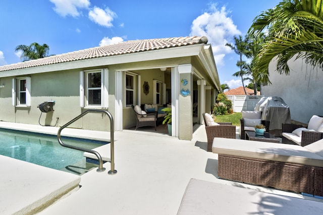 back of house featuring a tile roof, an outdoor hangout area, stucco siding, a fenced in pool, and a patio
