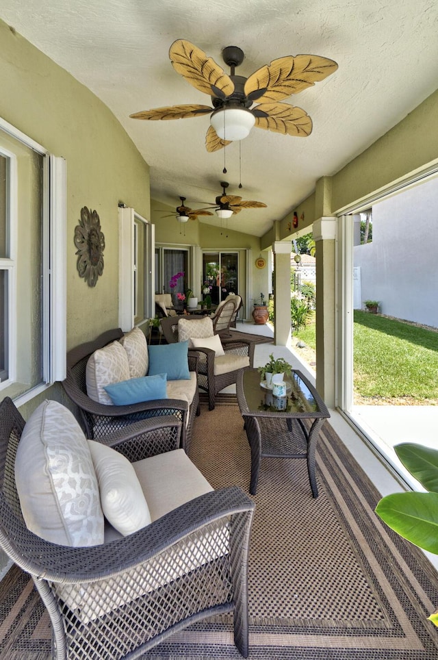 sunroom featuring an outdoor hangout area and a ceiling fan
