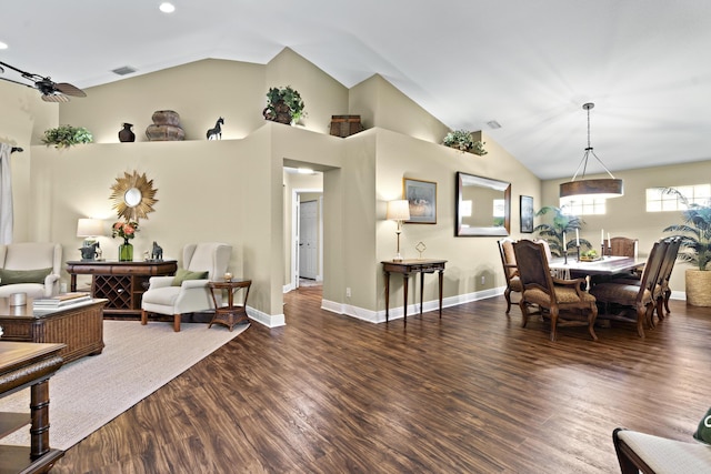 dining area featuring baseboards, visible vents, wood finished floors, and lofted ceiling