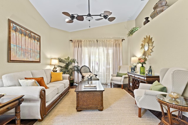 living room with ceiling fan, wood finished floors, and lofted ceiling