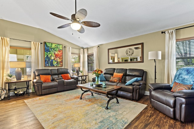 living room with a ceiling fan, baseboards, wood finished floors, and lofted ceiling