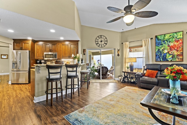 living area with baseboards, recessed lighting, ceiling fan, and wood finished floors