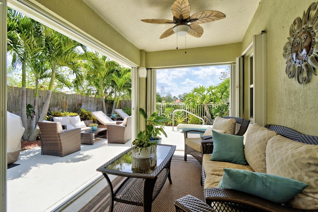 view of patio / terrace featuring ceiling fan, an outdoor living space, and a fenced backyard
