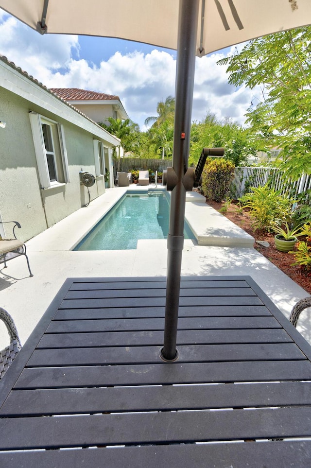 view of pool with a fenced in pool, a fenced backyard, and a patio area