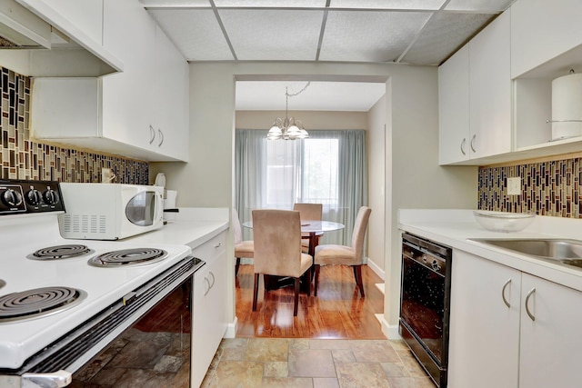 7451 NW 16th St Unit 303, Plantation, FL 33313 - kitchen featuring light countertops, a drop ceiling, white cabinetry, and white appliances