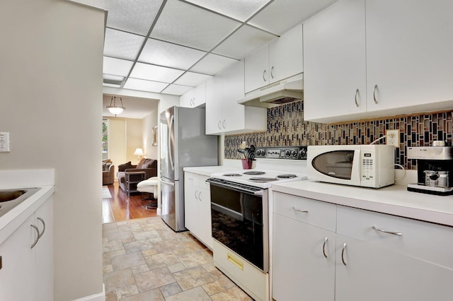 7451 NW 16th St Unit 303, Plantation, FL 33313 - kitchen with tasteful backsplash, white appliances, light countertops, white cabinets, and under cabinet range hood