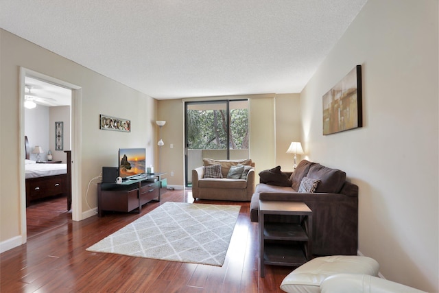7451 NW 16th St Unit 303, Plantation, FL 33313 - living area with baseboards, a ceiling fan, wood finished floors, and a textured ceiling