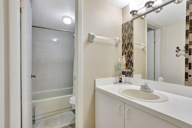 7451 NW 16th St Unit 303, Plantation, FL 33313 - full bathroom featuring shower / tub combo, vanity, a textured ceiling, and toilet