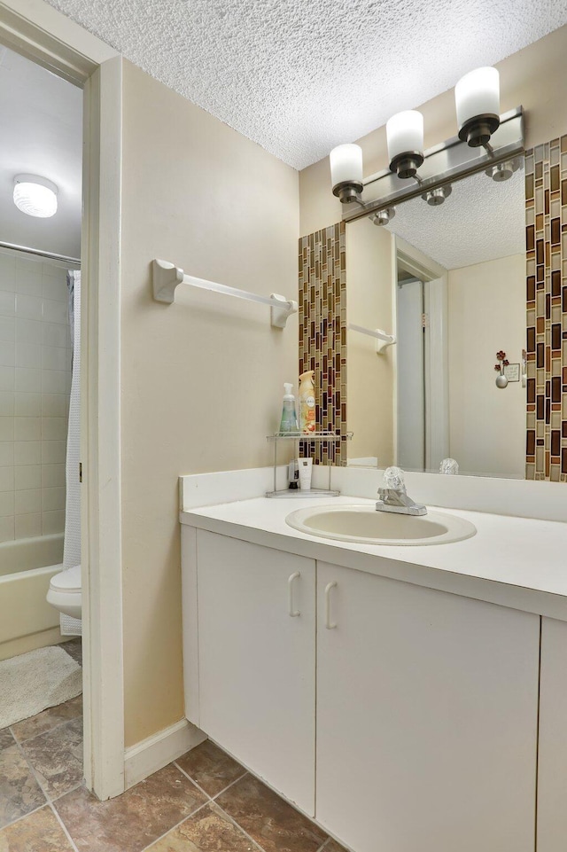 7451 NW 16th St Unit 303, Plantation, FL 33313 - bathroom with baseboards, vanity, a textured ceiling, and shower / tub combo with curtain