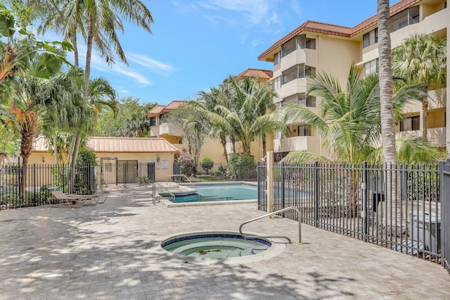 7451 NW 16th St Unit 303, Plantation, FL 33313 - pool featuring fence, a hot tub, and a patio