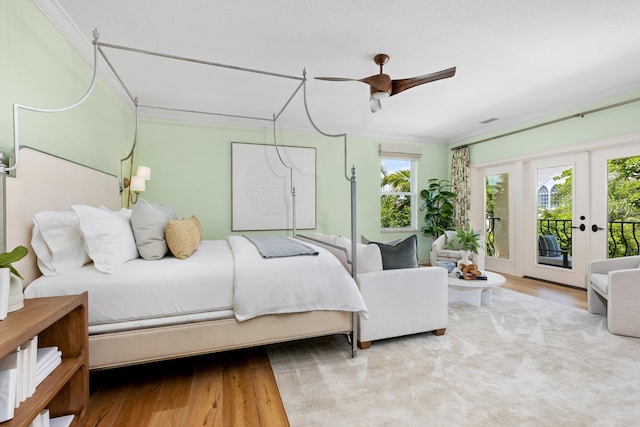 bedroom featuring wood finished floors, access to exterior, crown molding, and a ceiling fan
