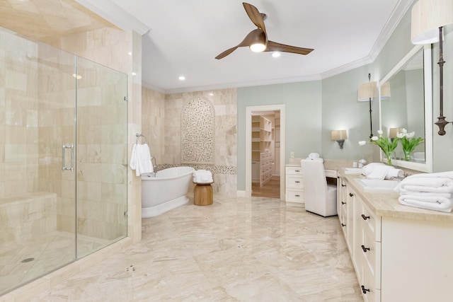 full bathroom featuring a freestanding bath, a stall shower, ceiling fan, vanity, and ornamental molding