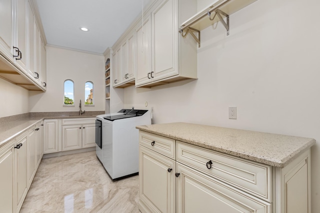 clothes washing area with washer and clothes dryer, a sink, marble finish floor, cabinet space, and recessed lighting