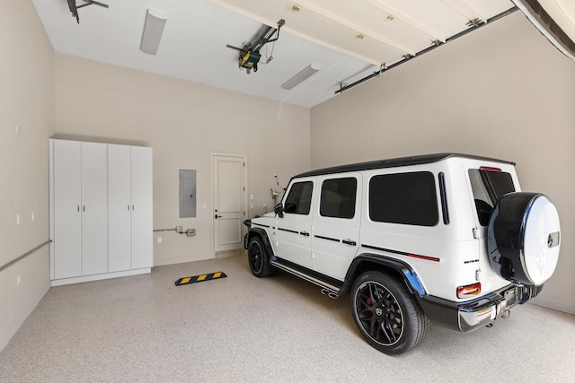 garage featuring electric panel, baseboards, and a garage door opener
