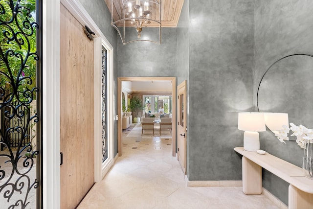entryway with a chandelier