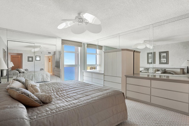 1360 S Ocean Blvd Unit 2508, Pompano Beach, FL 33062 - bedroom with a textured ceiling, light carpet, and a ceiling fan