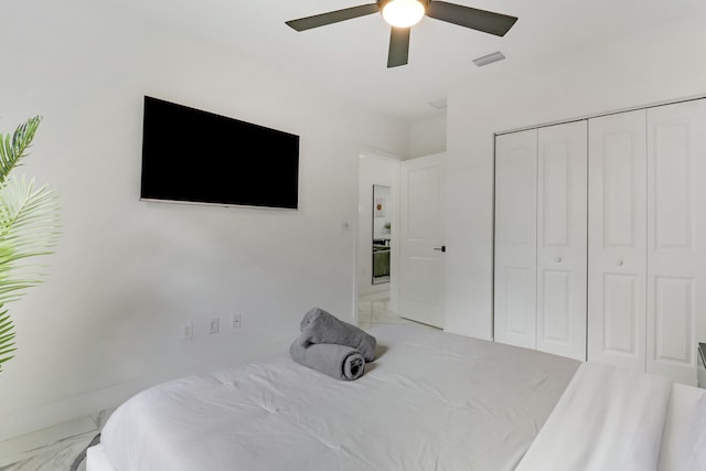 626 33rd St, West Palm Beach, FL 33407 - bedroom featuring marble finish floors, a closet, and ceiling fan