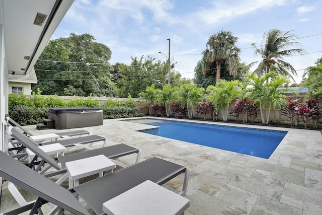 626 33rd St, West Palm Beach, FL 33407 - view of pool with a patio, a hot tub, and a fenced backyard