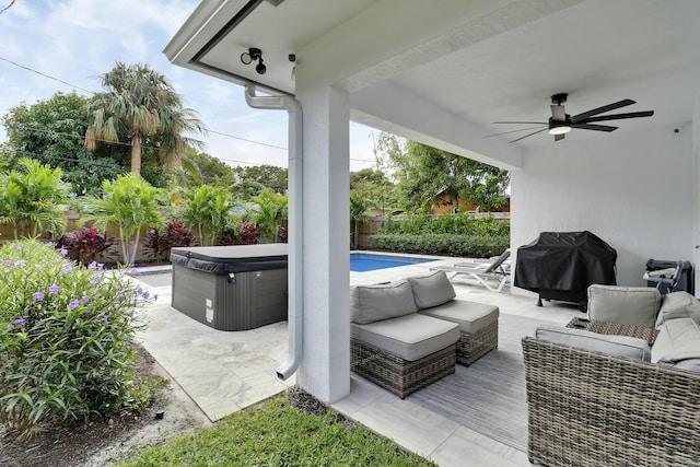 626 33rd St, West Palm Beach, FL 33407 - fenced backyard with a ceiling fan, an outdoor hangout area, a hot tub, and area for grilling