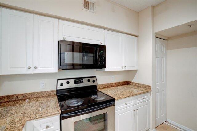 2221 Tuscany Way, Boynton Beach, FL 33435 - clothes washing area featuring stacked washer and clothes dryer and baseboards