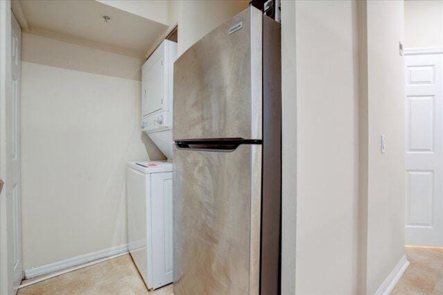 2221 Tuscany Way, Boynton Beach, FL 33435 - kitchen featuring white cabinets, a sink, a textured ceiling, light stone countertops, and appliances with stainless steel finishes