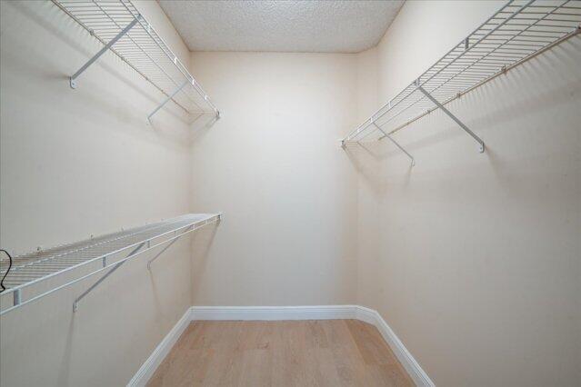 2221 Tuscany Way, Boynton Beach, FL 33435 - bedroom with baseboards, visible vents, light wood-style floors, and a closet